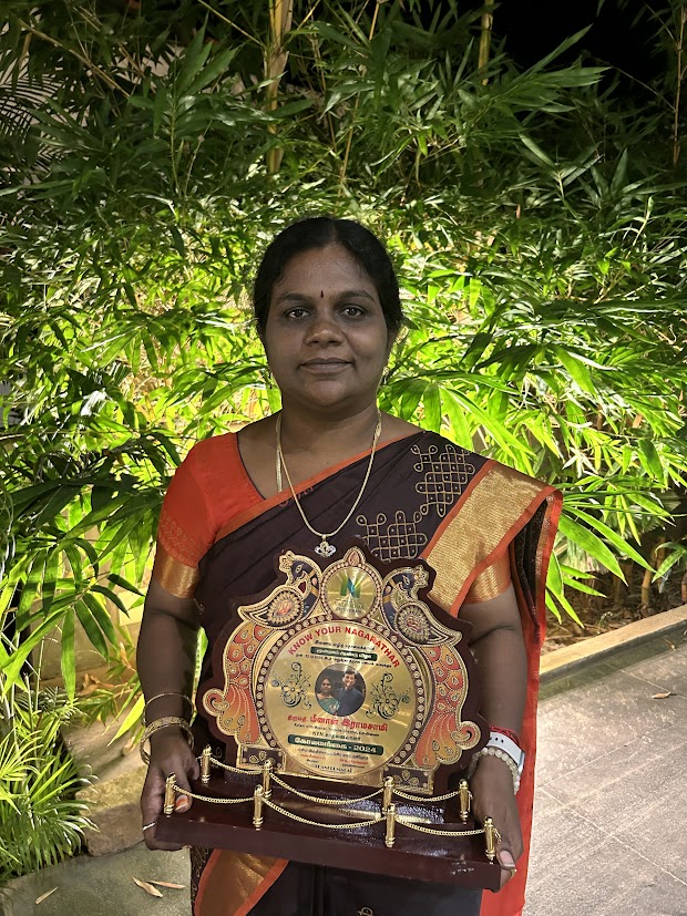 Meena Ramasamy holding the Know Your Nagarathar Kola Mangai award shield