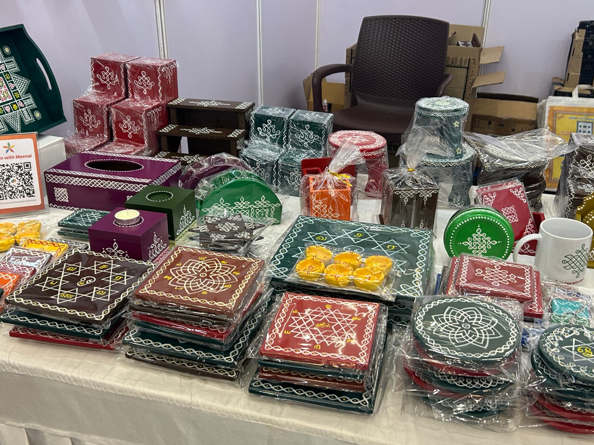 Stacks of hand-painted kolam manai and pooja boards