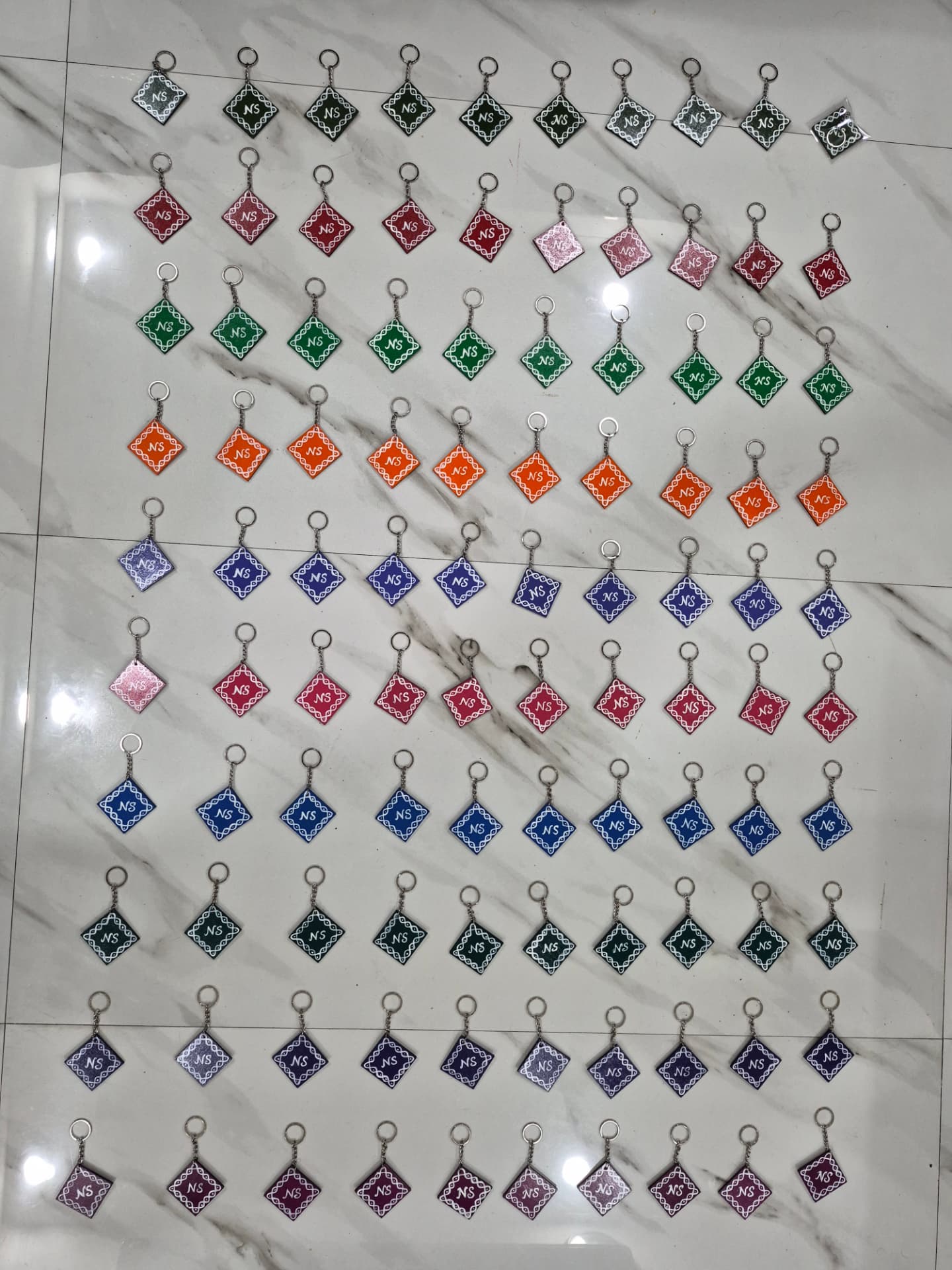 100 Kolam Key Chains with Groom & Bride Initials "NS" — Marriage Return Gift — Bulk Order | Kolam with Meenal bulk order