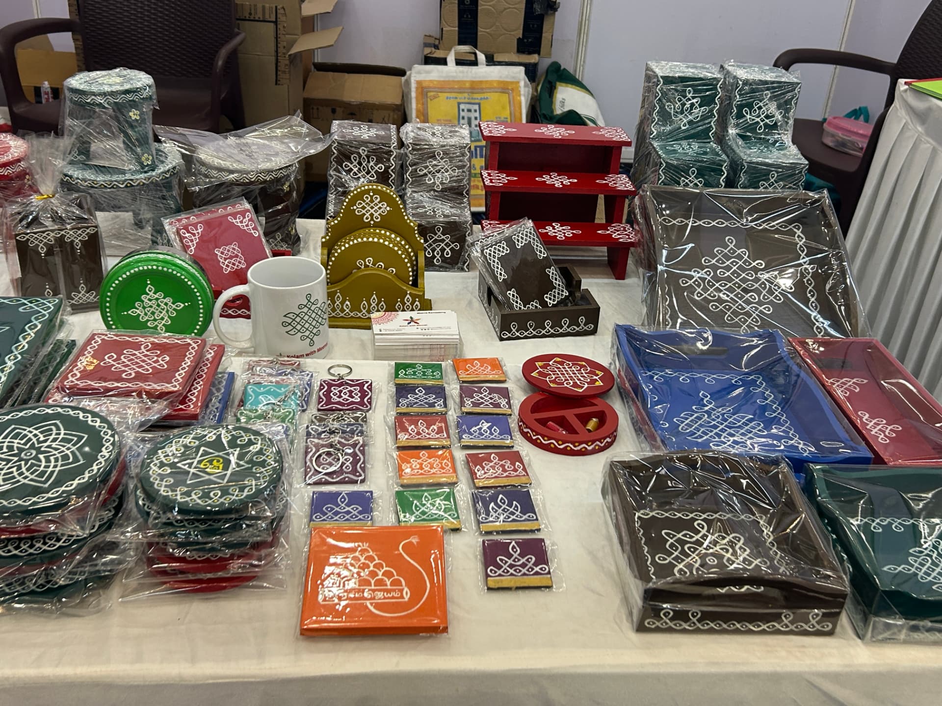 Kolam coasters, mugs, keychains and magnets on display