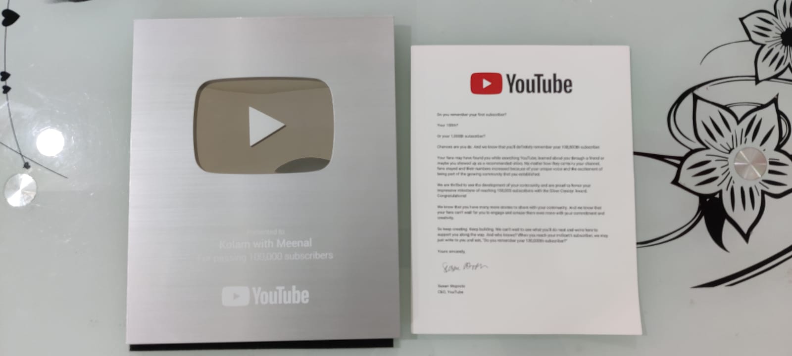 The YouTube Silver Play Button awarded to Kolam with Meenal with the congratulatory letter