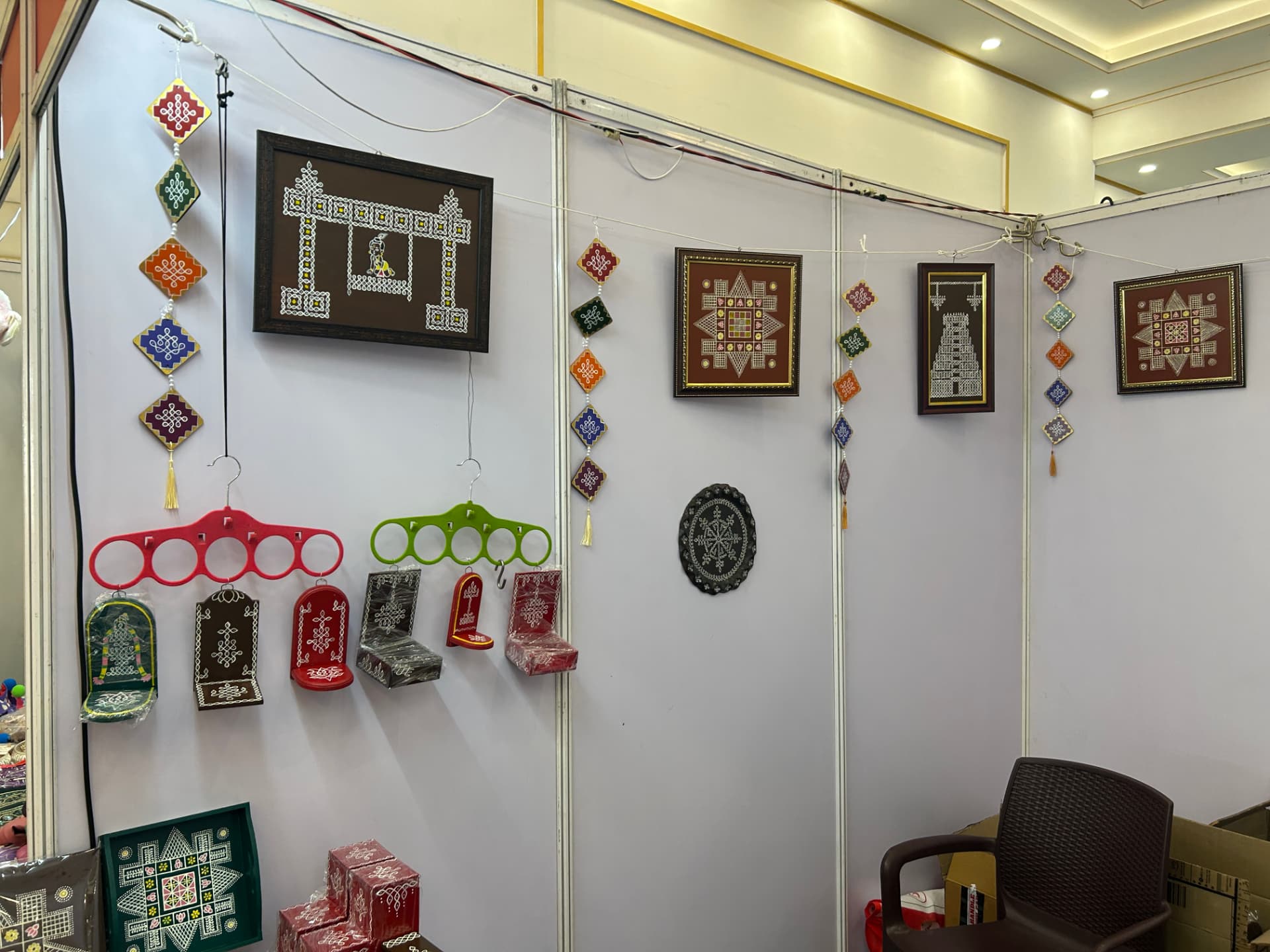 Framed kolam art and wall hangings at the stall