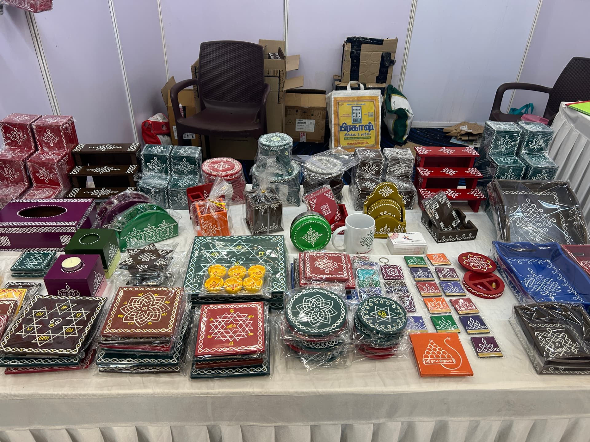 Hand-painted kolam trays, boxes and coasters on display